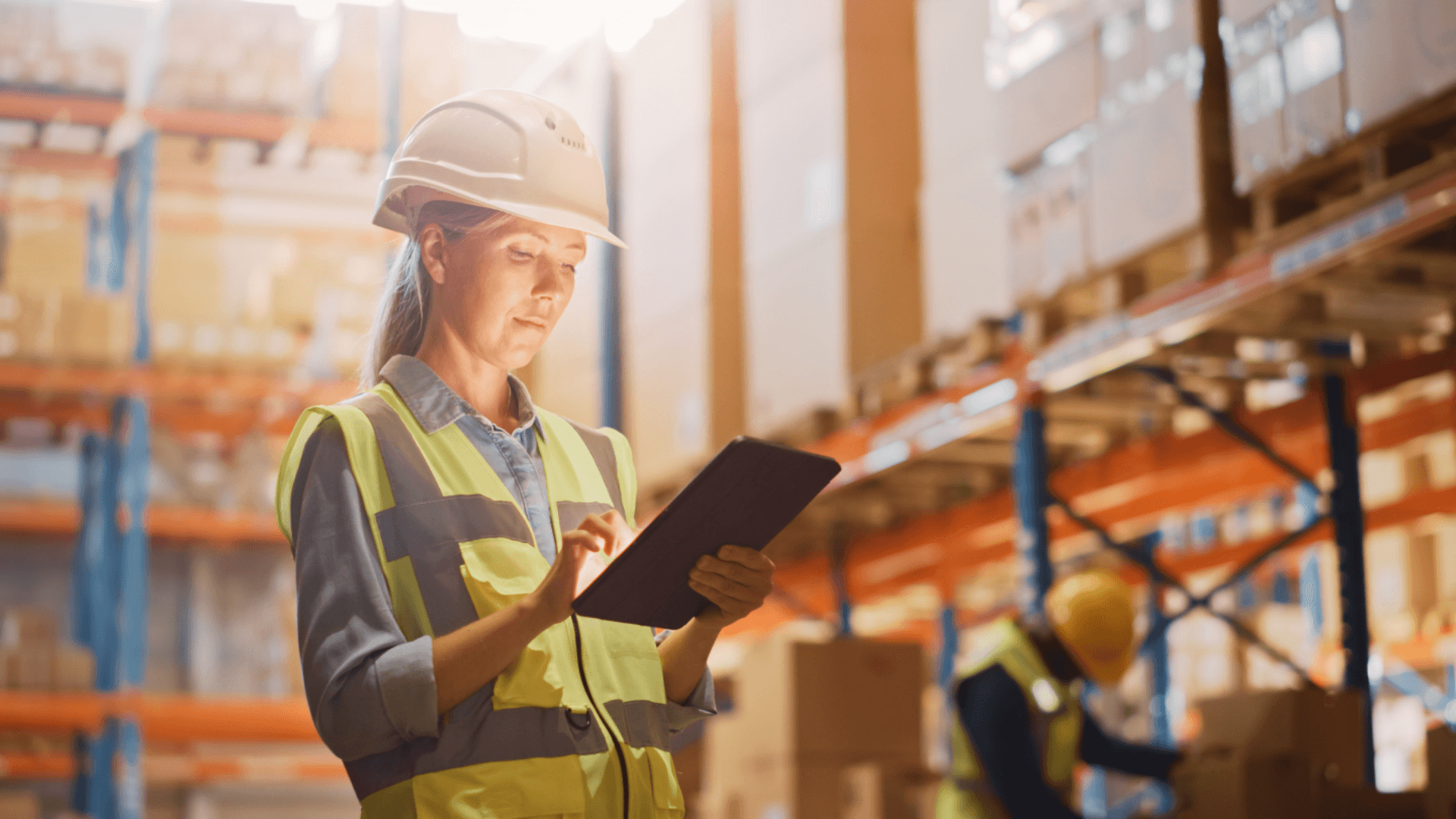 lady in a distribution centre looking at a tablet